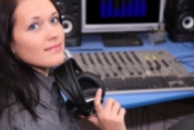 A young smiling woman in radio studio
